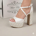 Pearl White high-heeled sandals with pearl embellishments on a neutral background