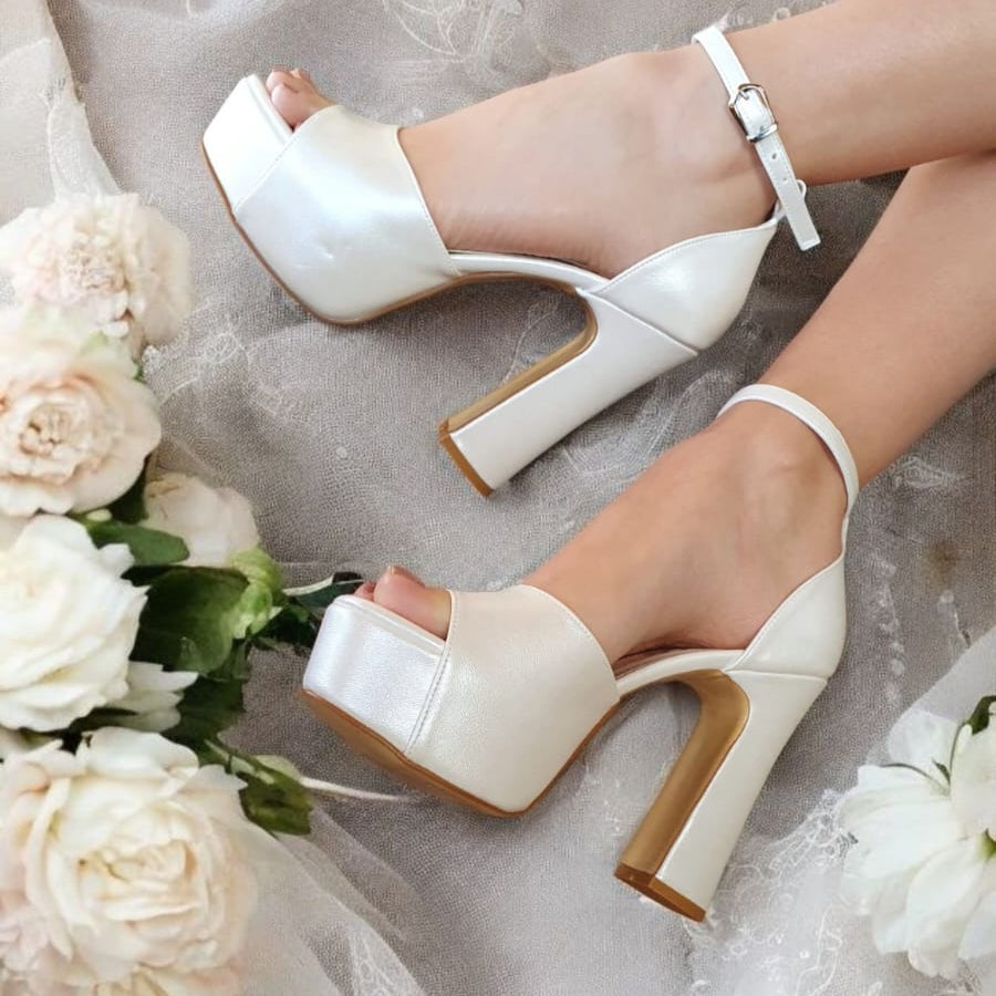 Elegant pearl white platform bridal heels with an ankle strap and block heel, designed for comfort and style. Perfect wedding shoes for brides in Beirut, Lebanon. Try before you buy with home delivery.
