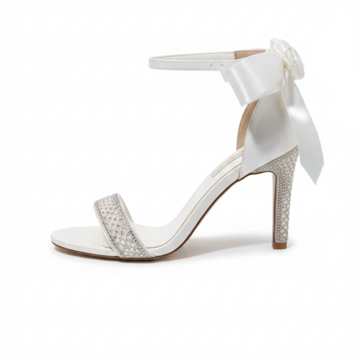 White sandal with a bow on a white background