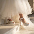 Sophisticated matte white high-block-heel bridal platforms, perfect for a luxury destination wedding.